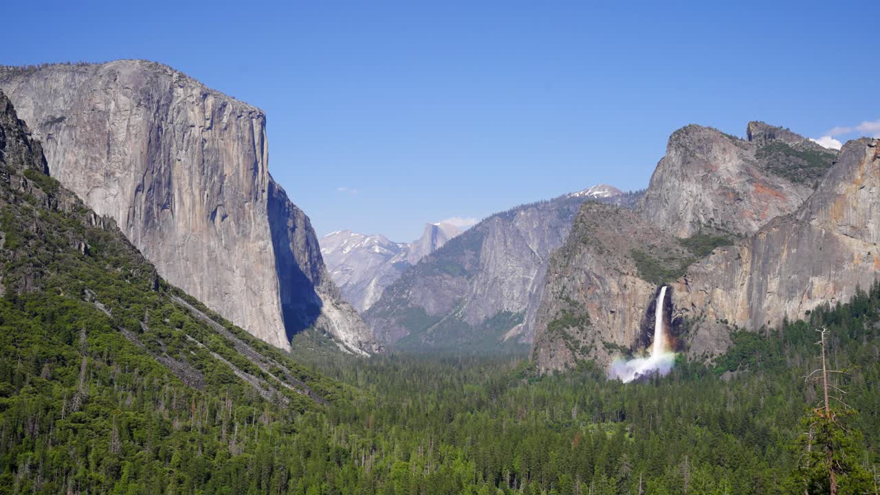 Bridalveil Fall with an afternoon rainbow in a wide shot of Tunnel View in Yosemite National Park