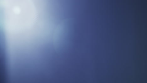 soft blue lens flare with a gentle light gradient across a clear black background. ideal for overlays, transitions, visual effects, or adding atmosphere to creative projects