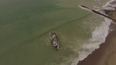toma aérea sobre un barco de pesca naufragado cerca de ventura california 4