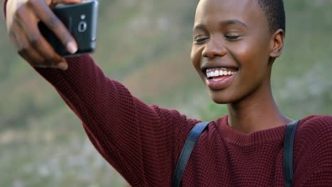 Woman-taking-selfie-with-mobile-phone-at-countryside-4k