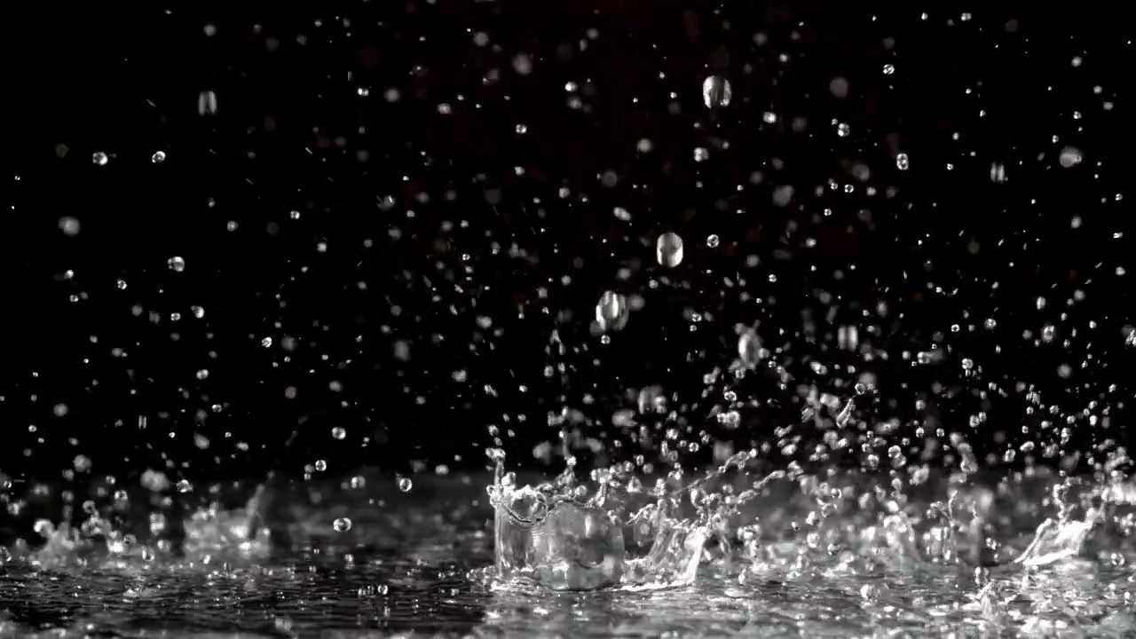 Slow Motion Rain Droplets Splashing on a Dark Surface