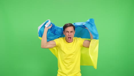 Ukrainian fan celebrating with flag on green screen