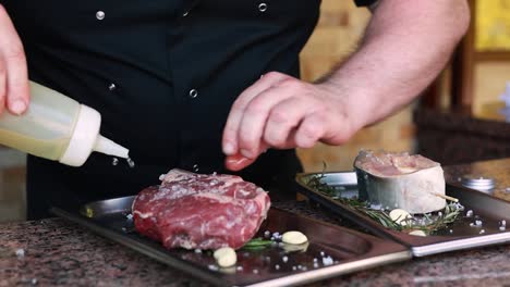 chef seasoning a rib eye steak