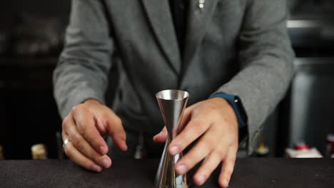bartender measuring liquor