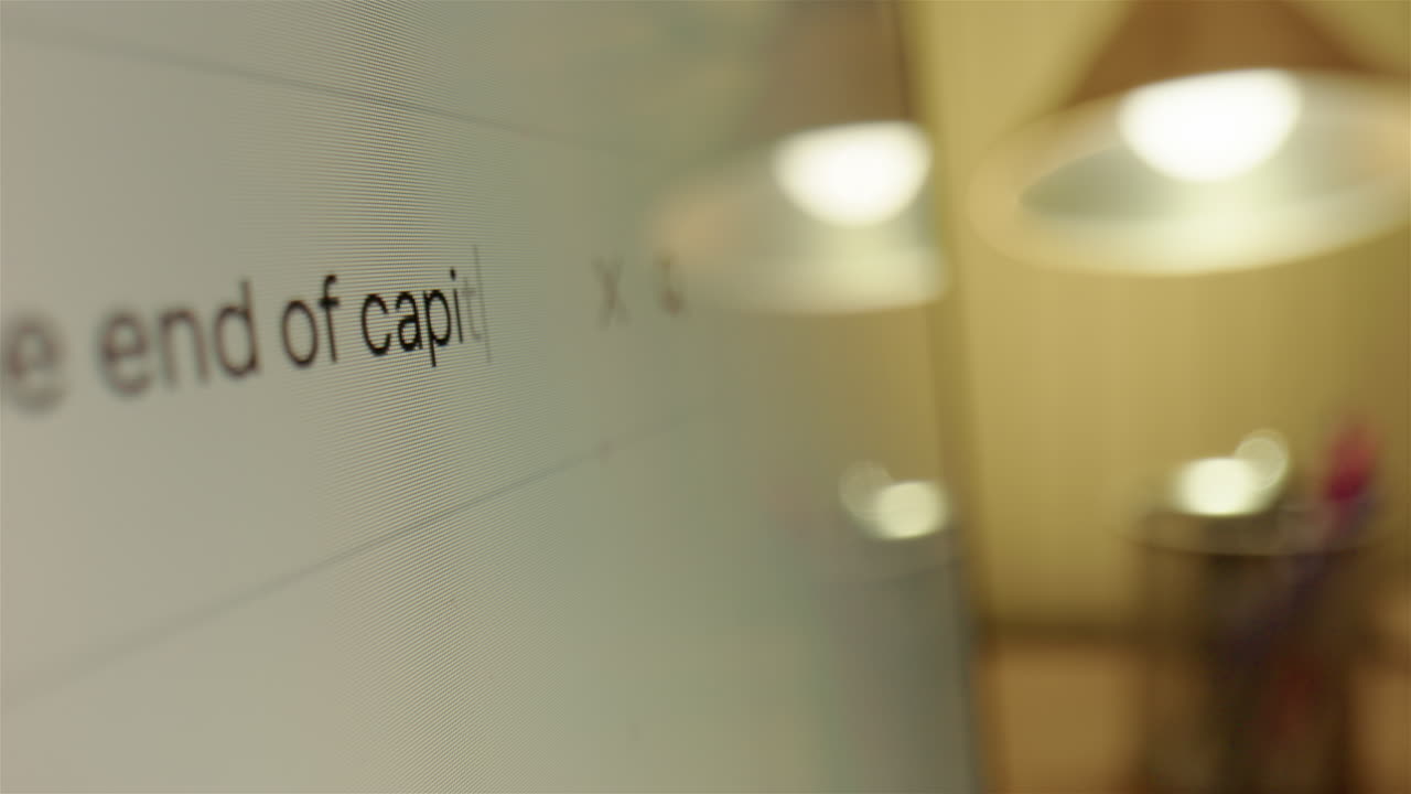 Asking the internet if it's the end of capitalism, closeup slider on monitor