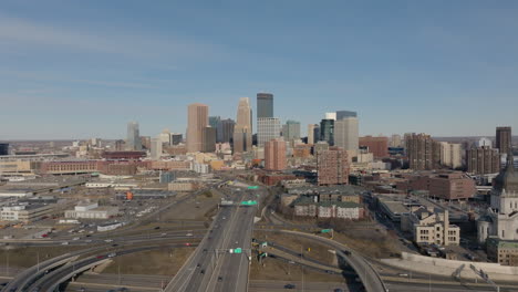 Aerial-drone-view-flying-over-traffic-and-buildings-in-the-Central-Downtown-Minneapolis-area-on-a-sunny-day