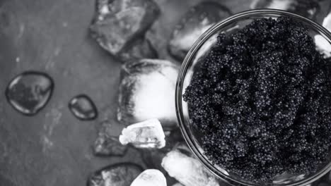 portion of black caviar rotating on a plate (close-up; seamless loopable)