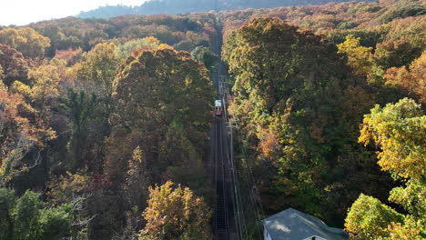 aerial footage flying through the colorful fall trees following the incline that is moving up lookout mountain in chattanooga, tn