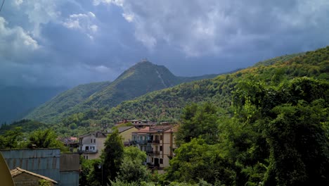 Ciudad-Escondida-En-Bosques-De-Montaña,-Contrastando-La-Luz-Del-Día-Y-Las-Nubes,-Montello,-Italia