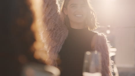 group of diverse friends hanging out dancing together enjoying rooftop party at sunset drinking alcohol having fun on weekend celebration