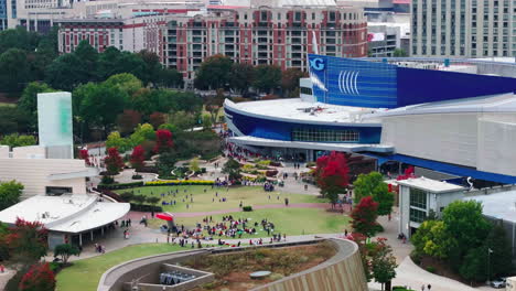 aerial footage of people in park in front of georgia aquarium