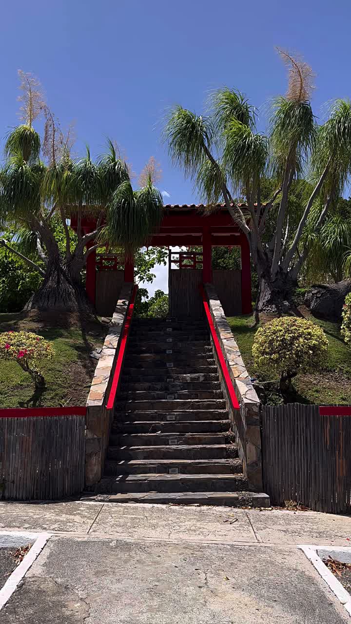 Japanese-style garden with red gate and stone steps