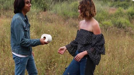 love blossoms as a woman hands a man her last roll of toilet paper during the covid19 coronavirus pandemic epidemic