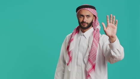 middle eastern guy doing stop gesture