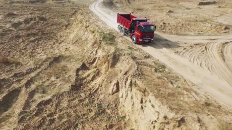 red dump truck on a quarry road