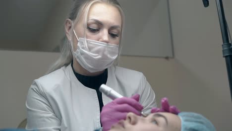 beautician in white coat over black pullover colours eyebrow