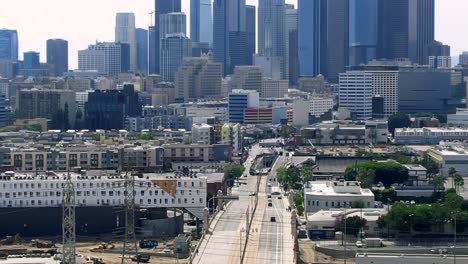 drone view of urban buildings in downtown los angeles over first street bridge cityscape and skyline