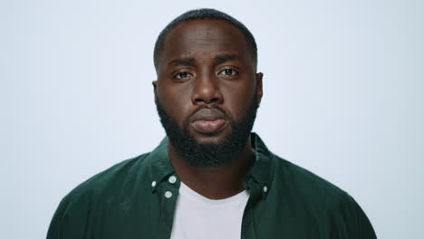 Portrait-of-serious-african-handsome-raising-head-in-grey-background.