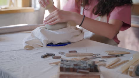 woman shaping clay bowl