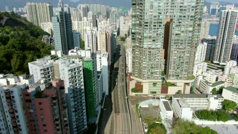 aerial shot of downtown hong kong mega residential skyscrapers and traffic, on a beautiful day