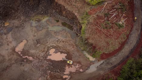 Aerial-view-of-an-excavator-removing-rock-in-an-open-quarry-in-Foz-do-Iguazu,-Brazil