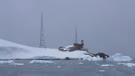 Base-Brown-Antarctica-Station,-Sailing-by-Buildings,-Floating-Ice