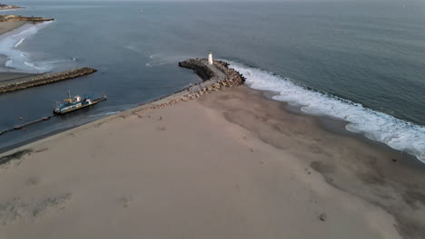 aerial view of santa cruz breakwater (walton) lighthouse shot in 4k high resolution
