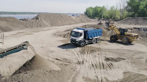 sand loading and transportation operations at a river port site