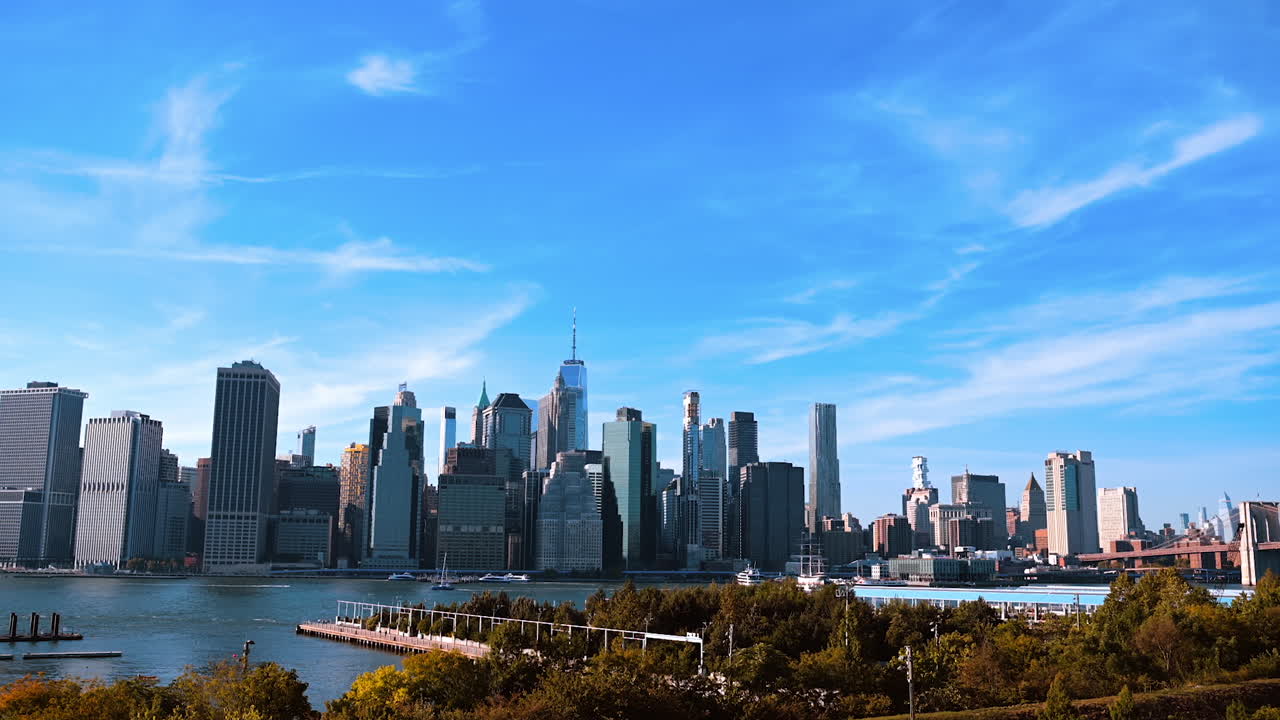 New York, USA, 9 August 2025: Panoramic view of Lower Manhattan skyline from Brooklyn. A beautiful panoramic view of Lower Manhattan skyline seen from Brooklyn with the East River and boats below