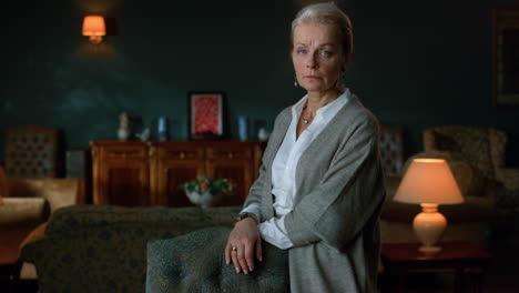 portrait senior woman posing in classic interior. old lady looking at camera