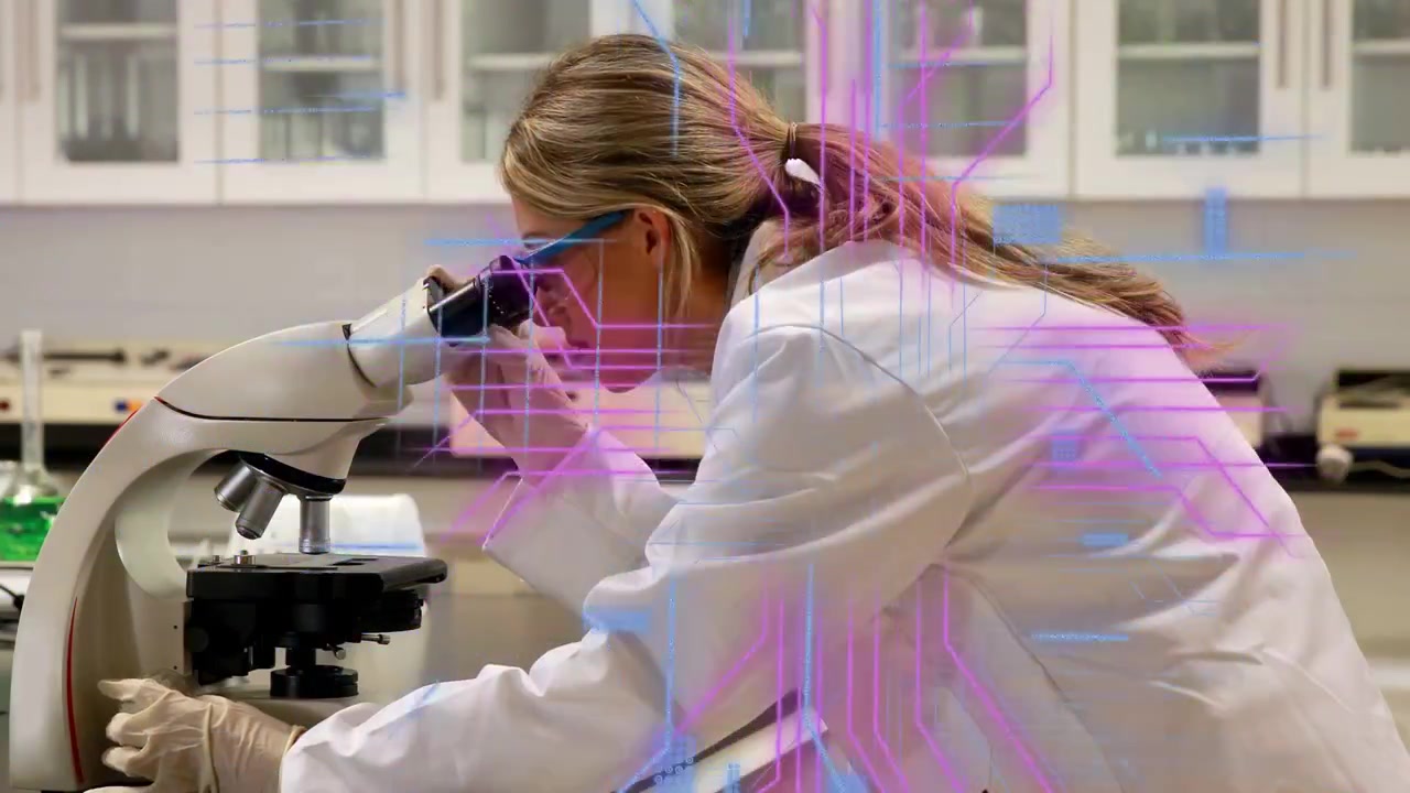 Lab researcher leaning and adjusting microscope focus, creating overlays for specimen clarity