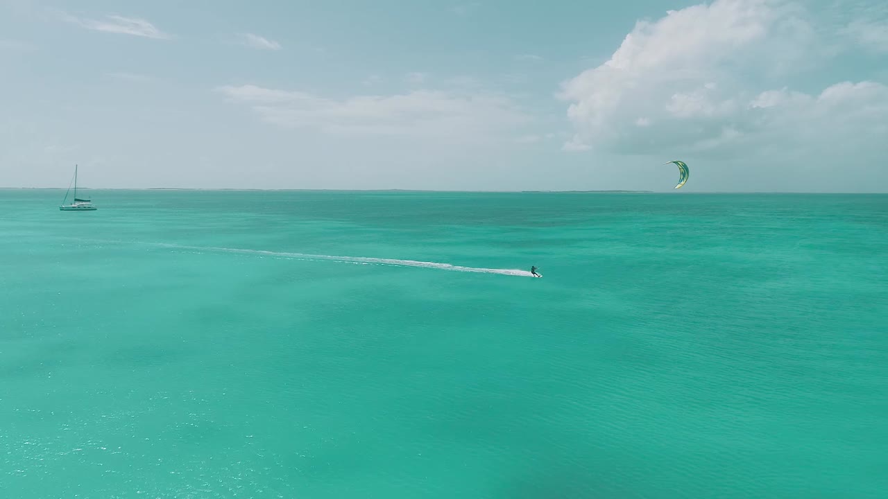 one Kitesufer in clear crystal water, from drone in Los Roques venezuela  Caribbean-sea  Fantastic landscape Moving aerial view