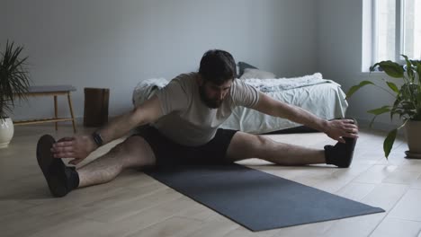 man stretching at home