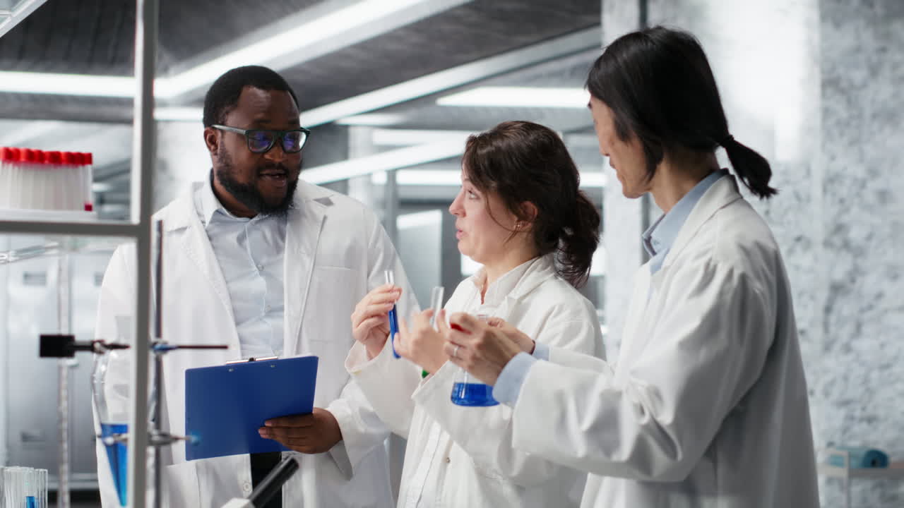 Vertical video Multiracial chemists using research facility vials filled with indicator solution