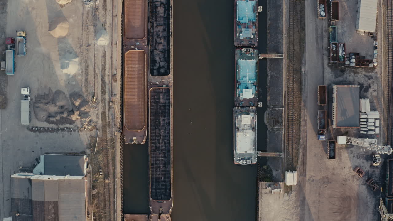 Aerial View of Industrial Port with Barges and Canal