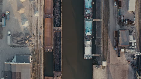 aerial view of industrial port with barges and canal