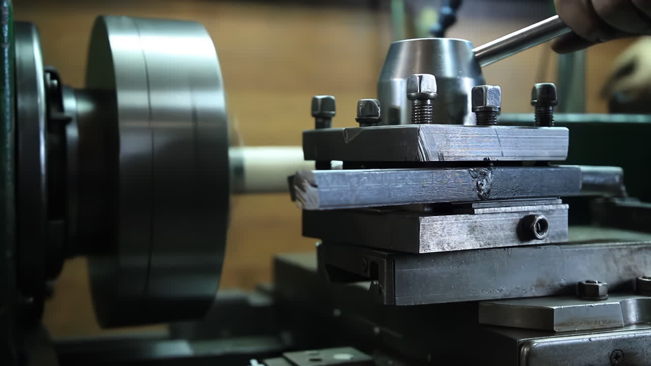 Lathe technician engineer worker service Skilled machinist working intently on a large industry in metal factory workshop with Large Machines