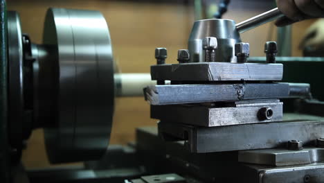 lathe technician engineer worker service skilled machinist working intently on a large industry in metal factory workshop with large machines