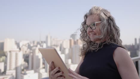 young-elderly-woman-using-technologies-tablet-inspiring