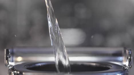 water pouring into a metal container