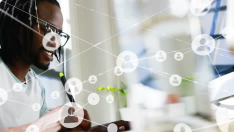 network of connections animation over person working at desk with pen