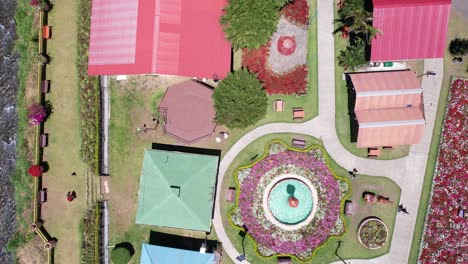 birdseye aerial view of colorful gardens, fountains and buildings on sunny day, boquete, panama