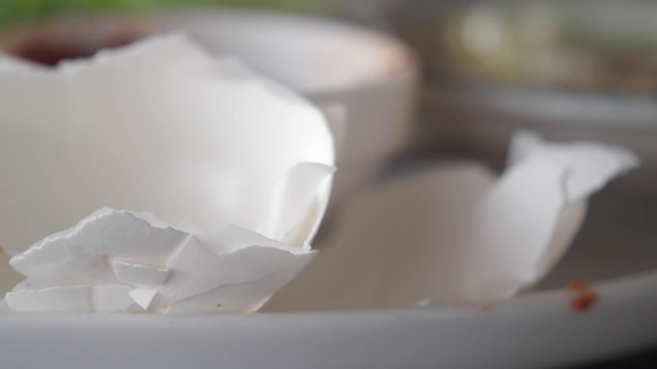 Close Up of Broken White Eggshells on a Plate