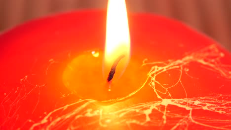 burning red candle close up