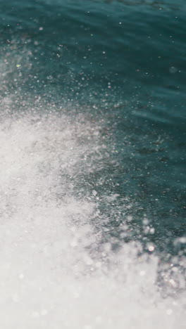 water splashes trace of sailing fast boat on calm water on summer day closeup. foamy track on sea surface behind motorboat. active leisure at seaside