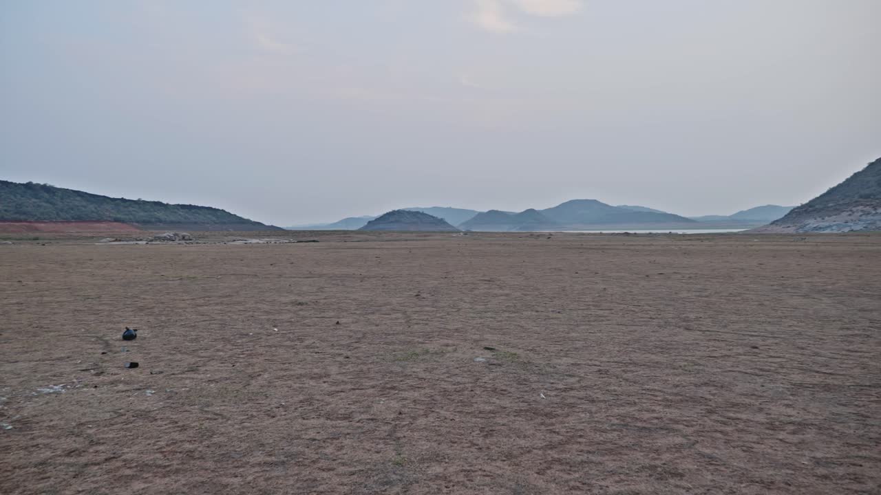 No water with sand and big hill mountain at vizag colony, nagarjuna sagar backwater, azmapur, nalgonda district, telangana, andhra pradesh, india. day time, pan shot, 4k.