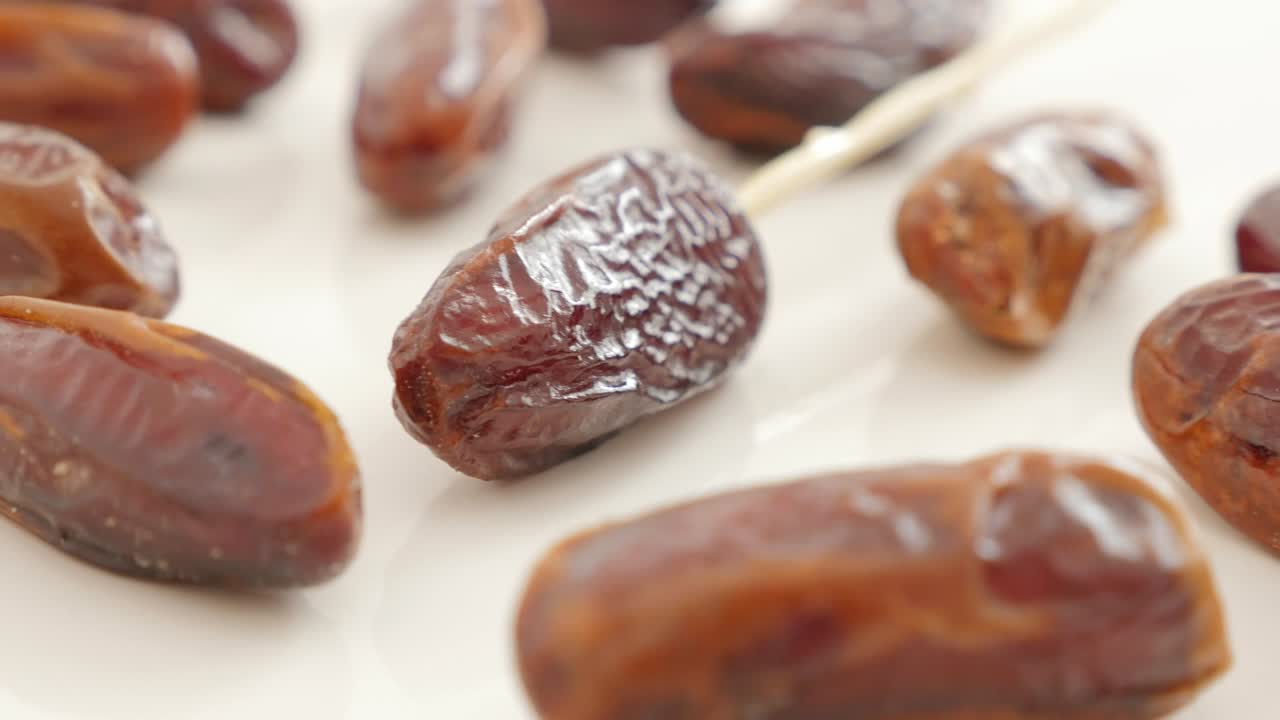 Dates exotic eastern palm fruit on white background slow panning 4K 2160p UltraHD footage - Tasty Phoenix dactylifera fruit on white slow pan close-up 4K 3840X2160 UHD video