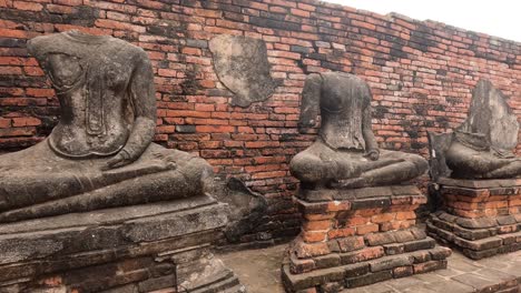 decapitated buddha statues at a historical site