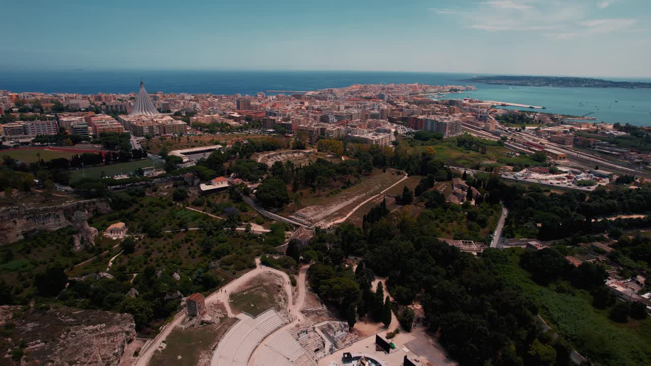 Ancient ruins in Siracusa archaeological park, including the Roman amphitheater and rock structures