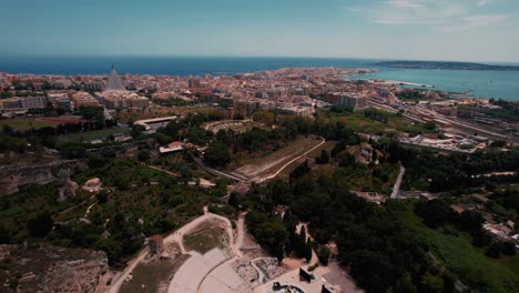 ancient ruins in siracusa archaeological park, including the roman amphitheater and rock structures